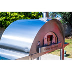 WPPO Karma 55-inch commercial wood-fired pizza oven showing stainless steel dome, front opening, and built-in temperature gauge