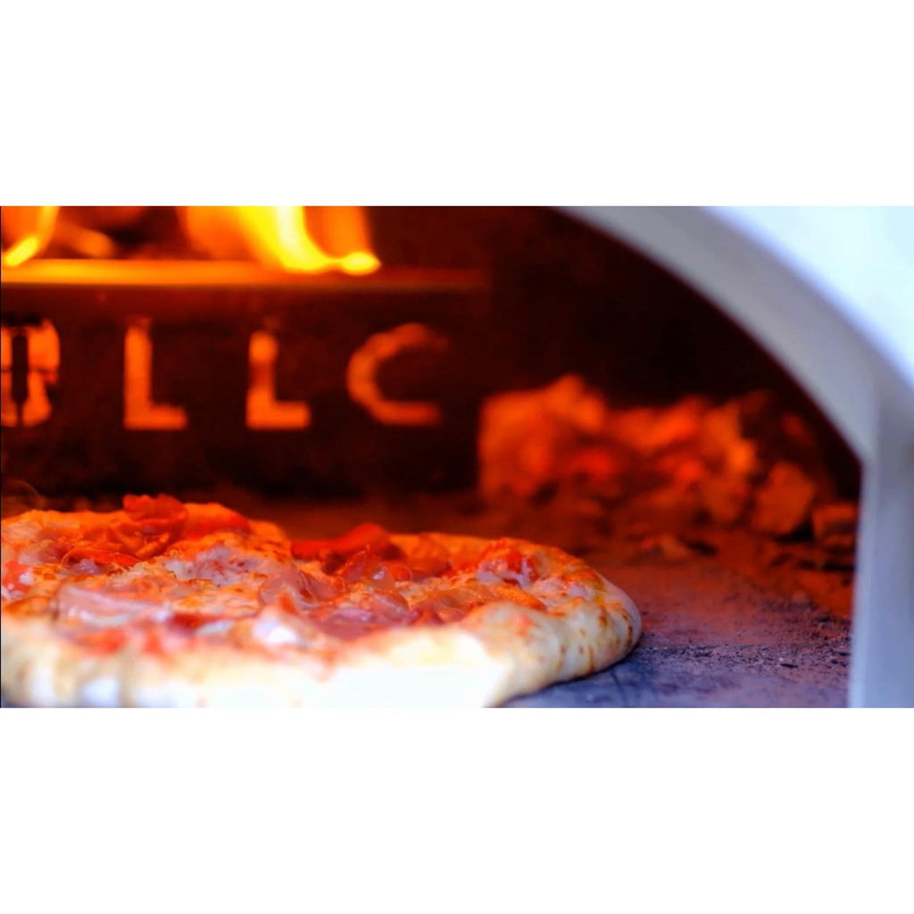 Pizza baking inside a WPPO Karma wood-fired pizza oven with flames and glowing embers
