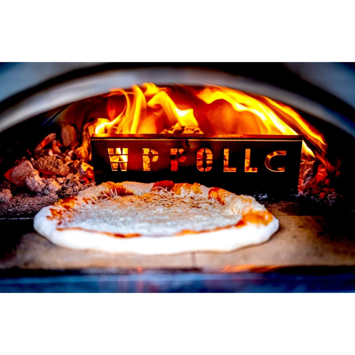 Pizza cooking inside a WPPO Karma wood-fired pizza oven with flames visible
