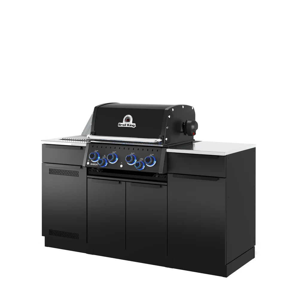 Angled right-side view of the Broil King Baron 490i Pro IR Shadow outdoor kitchen island featuring Shadow Black cabinetry, stainless steel countertops, four-burner gas grill, and blue illuminated control knobs.