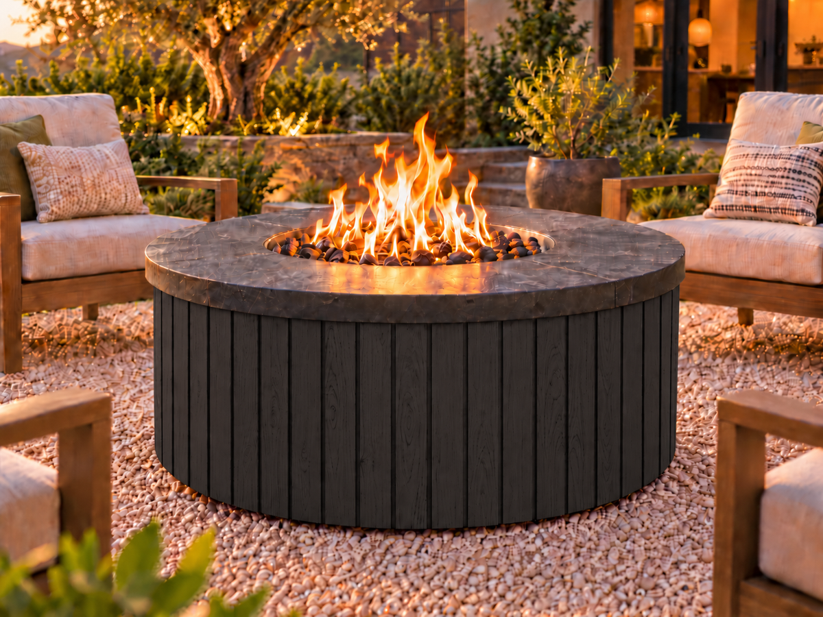 EZ Finish Firefly 48-inch round fire pit with Universal 4+4 aluminum cladding in Black finish, shown lit in an outdoor patio setting.