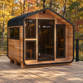 ALEKO Bluet 6-person red cedar outdoor sauna on a backyard deck surrounded by autumn trees.