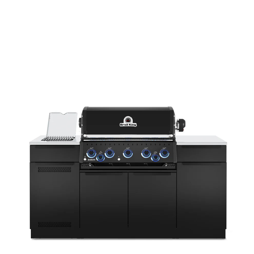 Front view of the Broil King Baron 590i Pro IR Shadow outdoor kitchen island with black cabinetry, stainless steel countertops, infrared side burner, and illuminated control knobs.