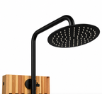 Matte black rainfall showerhead with curved arm mounted on a cedar outdoor shower panel.