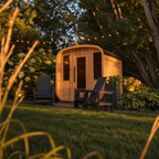 ALEKO Arnica 6-Person Rustic Cedar Outdoor Sauna in a landscaped backyard garden at dusk with warm interior lighting and outdoor lounge chairs