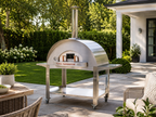 WPPO Karma 55-inch commercial wood-fired pizza oven on a stainless steel mobile cart in a backyard patio setting