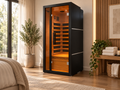 ALEKO Oasis 1-Person Infrared Sauna with black exterior and illuminated Canadian hemlock interior in a modern home wellness space