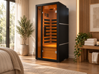 ALEKO Oasis 1-Person Infrared Sauna with black exterior and illuminated Canadian hemlock interior in a modern home wellness space