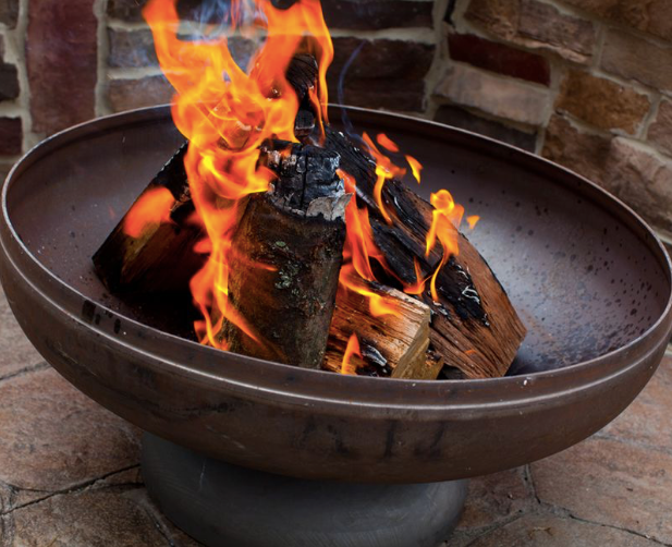 Ohio Flame Patriot fire pit with burning wood and natural steel patina