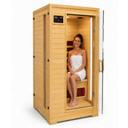 HeatWave Buena Vista 1–2 person hemlock infrared sauna with an adult seated inside and the glass door open