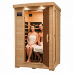 HeatWave Coronado 2-person hemlock infrared sauna with two adults seated inside on a white background